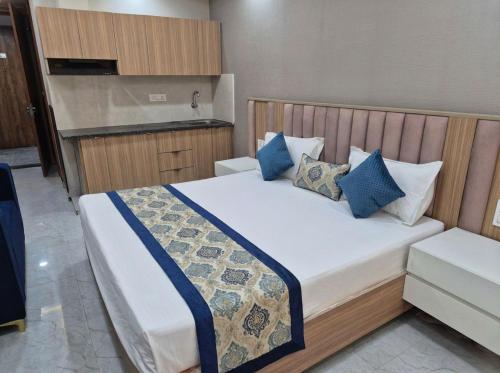 a bedroom with a large bed with blue pillows at Hotel Grand Luxury Char Dham in Vrindāvan