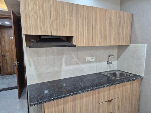 a kitchen with a sink and a counter top at Hotel Grand Luxury Char Dham in Vrindāvan