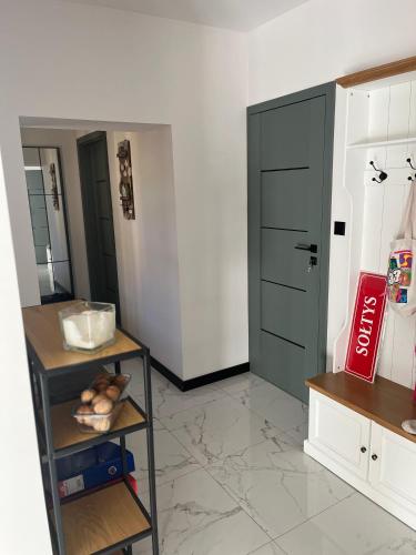 a room with a door and a shelf with bread at Agroturystyka Wiejska Przystań Bory Tucholskie in Słupy