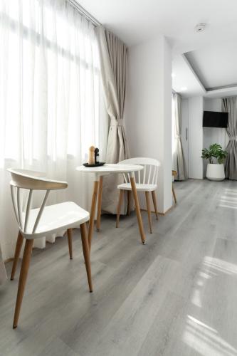 a living room with a table and two chairs at Cosy 1 Bedroom Studio with King Bed Kitchenet in Central Kathmandu with Terrace in Kathmandu