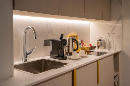 a kitchen counter with a sink and a coffee maker at InterContinental Lusaka by IHG in Lusaka