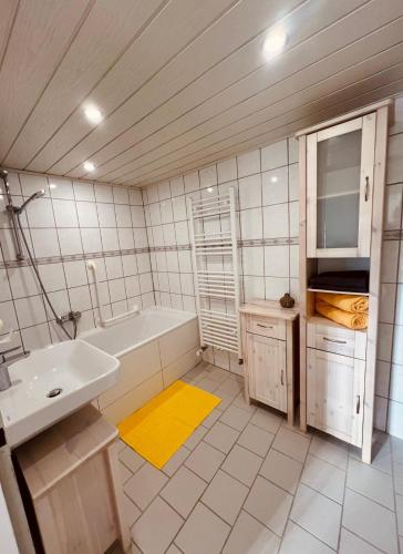 a bathroom with a tub and a sink and a bath tub at Fewo Geib in Meisenheim