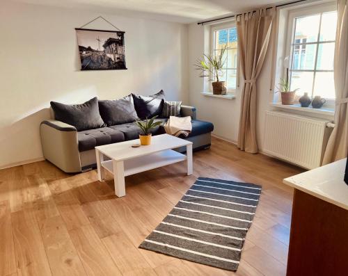 a living room with a couch and a coffee table at Fewo Geib in Meisenheim