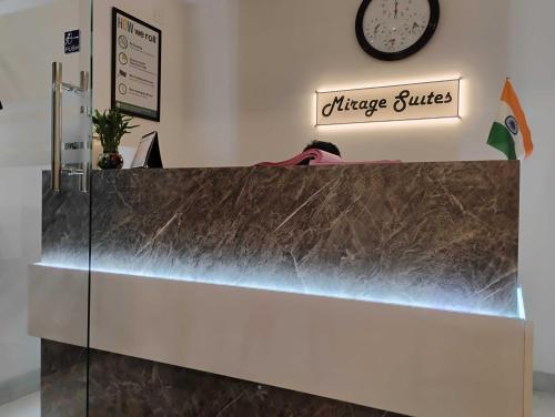 a counter in a restaurant with a clock on the wall at Hotel O Mirage Suites in Bengaluru
