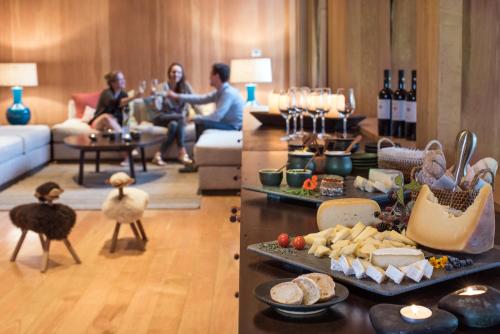 two pictures of a living room with food and people at andBeyond Vira Vira in Pucón
