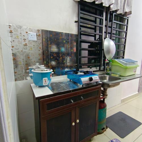东贡岸Cybercity Jannath homestay near to Airport KKIA的厨房配有带水槽和台面的台面