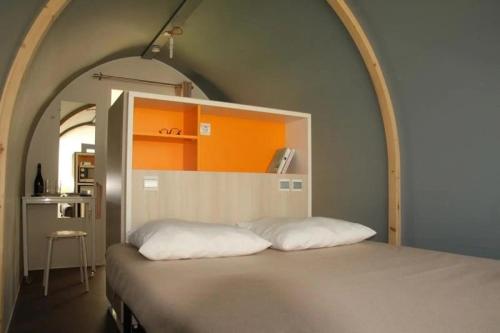 a bedroom with a bed with an arch above it at Camping 3 étoiles - Piscine - eeeddg in Saint-André-des-Eaux
