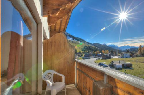 a balcony with a window with a view of a mountain at Hotel Relais Alpin in Les Mosses