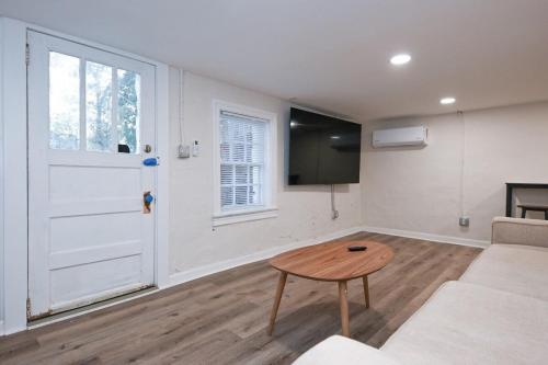 a living room with a couch and a table at Bobbin Mills Studio - 1 mile from Downtown Athens in Athens