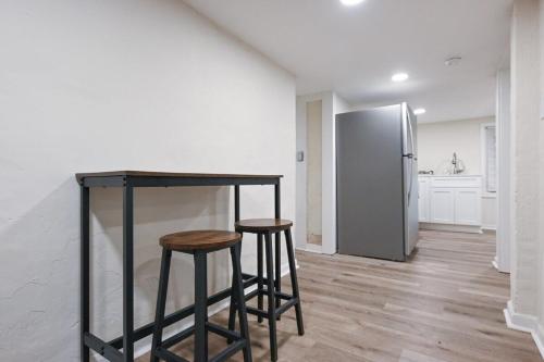 a kitchen with two bar stools and a refrigerator at Bobbin Mills Studio - 1 mile from Downtown Athens in Athens