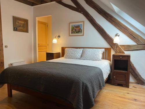 a bedroom with a large bed in a attic at Domaine Le Rianon in Malleret-Boussac