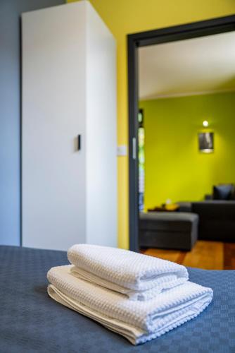 three white towels sitting on a table in a room at Kaktus Chill & Sleeping - 50 m od Rynku in Racibórz