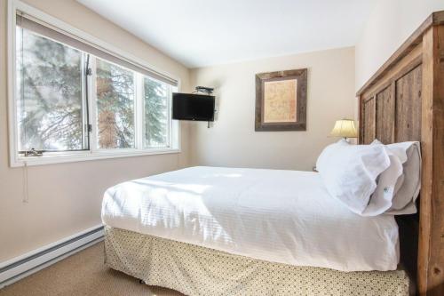 a bedroom with a large white bed and a window at RMR: Balsam Lodge B4 Condo in The AspensWilson WY in Wilson