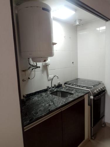 a kitchen with a sink and a counter top at 143 Boutique in Villa Gesell