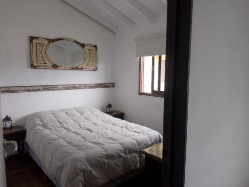a bedroom with a bed and a mirror on the wall at 143 Boutique in Villa Gesell