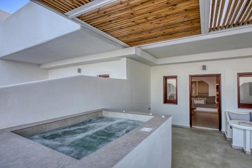 a swimming pool in the middle of a house at Splendour Hotel and Suites in Firostefani