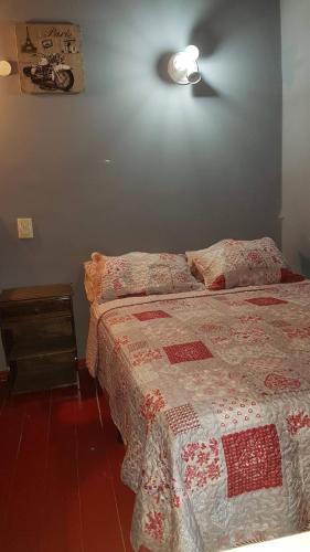 a bedroom with a bed with a quilt on it at Duplex En Iguazu in Puerto Iguazú