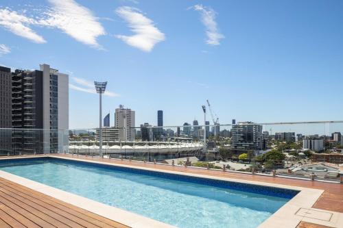a swimming pool on the roof of a building at Lux1BR Near Stadium, Parking & Balcony in Brisbane