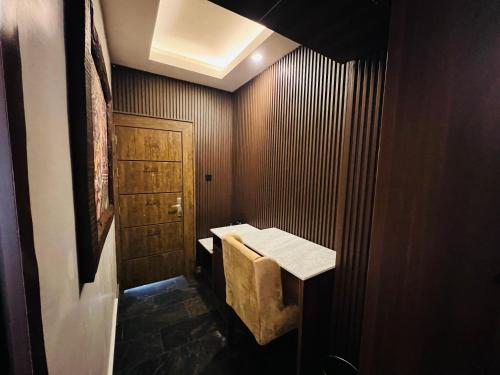 a bathroom with a sink and a wooden door at Presken Hotels @ Freedom Way, Lekki in Lekki