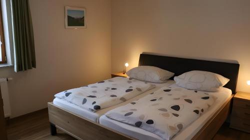 a bed with two pillows on it in a bedroom at Scharbachhof in Glottertal