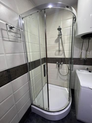 a glass shower in a bathroom with a toilet at Luxury South Beach Hotel in Batumi