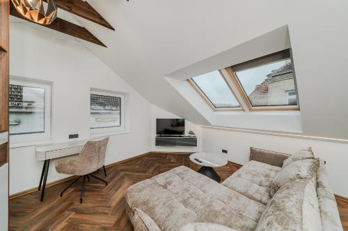 a living room with a couch and a table at Chamber Luxury House in Kaunas