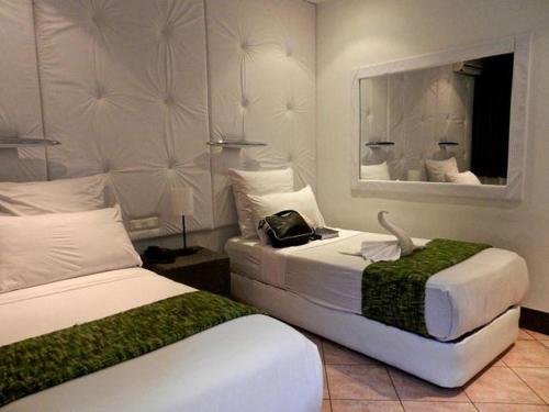 Ένα ή περισσότερα κρεβάτια σε δωμάτιο στο Villa das Mangas Garden Hotel