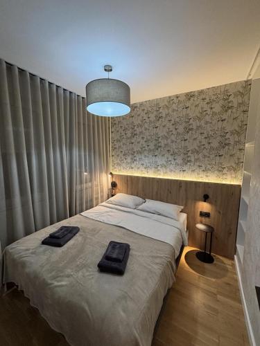 a bedroom with a bed with two towels on it at Urban Nest Belgrade in Belgrade