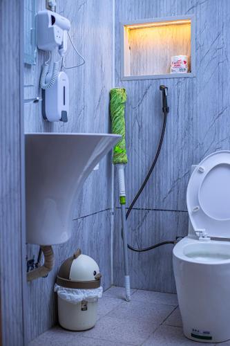 a bathroom with a sink and a toilet at Serene 1bed, 1bath studio Apartment in Mbarara