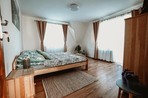 een slaapkamer met een bed en 2 grote ramen bij Widokowy Zakątek u Kamila in Zakopane