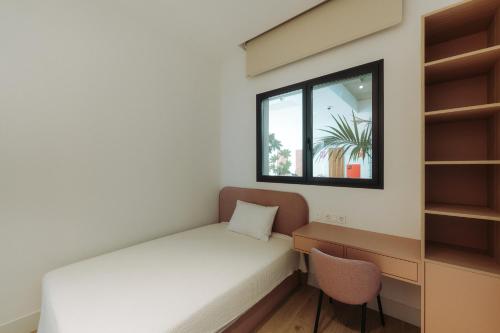 a small room with a bed and a window at Apartamentos - Delfin Natura in L'Alfas del Pi