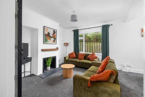 a living room with a couch and a table at 3BR Spacious Central Home in a Quiet Location in Montrose in Montrose