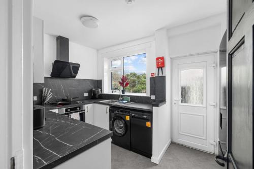 a kitchen with black and white appliances and a window at 3BR Spacious Central Home in a Quiet Location in Montrose in Montrose
