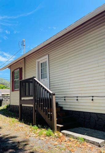 a house with a wooden ramp next to a building at Little Carnation in St. Augustine