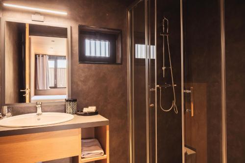 a bathroom with a sink and a shower at Les Prairies de la Mer in Grimaud