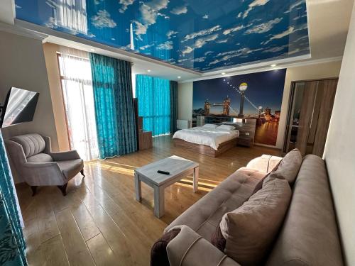 a living room with a couch and a bed at Hotel Skyline Batumi in Batumi