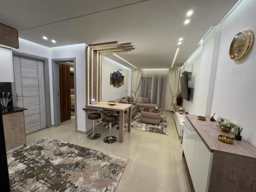 a kitchen and living room with a table and a couch at The View - Luxury One bedroom Apartment in Sharm El Sheikh
