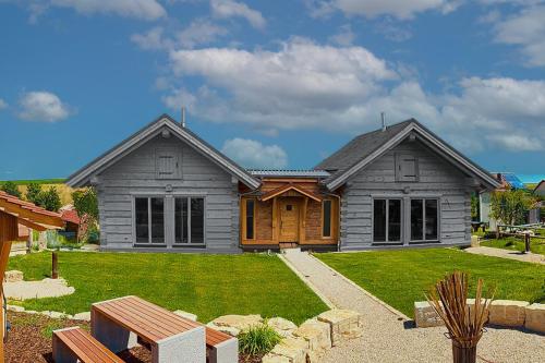 una casa gris con un patio con un patio en Chalets Waldeck - Urlaub im Fränkischen Seenland und Altmühltal, 