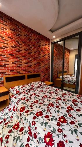 a bedroom with a bed with a floral comforter at Beautiful appartement with pool view in Mohammedia