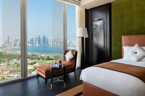 a hotel room with a bed and a large window at Banyan Tree Doha At La Cigale Mushaireb in Doha