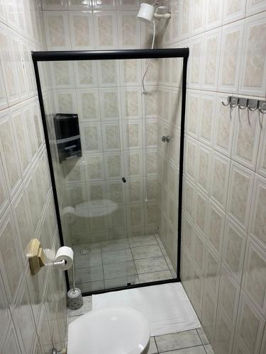 a shower with a glass door in a bathroom at Pousada Siri do Mar in Pontal do Paraná