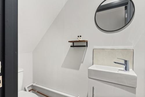 a white bathroom with a sink and a mirror at Modern 3-Bed Home, Super King Beds, Drive Parking in Birmingham