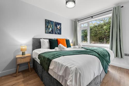 a bedroom with a large bed and a window at Modern 3-Bed Home, Super King Beds, Drive Parking in Birmingham