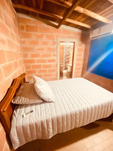a bedroom with a bed with a laptop on it at Casa Bora Bora in Sopetrán