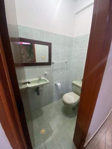 a bathroom with a toilet and a sink at Casa Bora Bora in Sopetrán