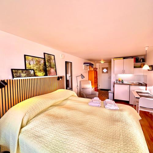 a bedroom with a large bed with two towels on it at Cosy apartment with private terrace in Vallensbæk