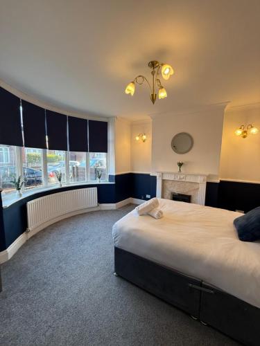 a bedroom with a large bed and a fireplace at Rochester House in Middlesbrough