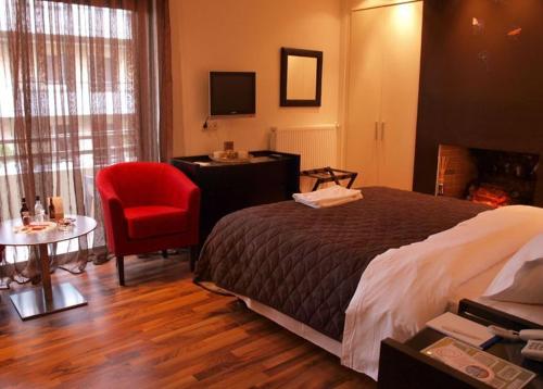 a hotel room with a bed and a red chair at Athens Habitat in Athens