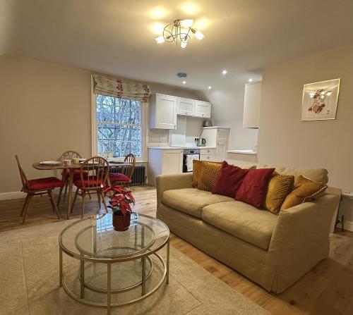 a living room with a couch and a table at Queens Terrace Apartments in Exeter