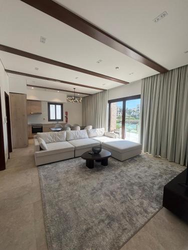 a large living room with a white couch and a table at Hawana Salalah Resort - FV 5 in Salalah